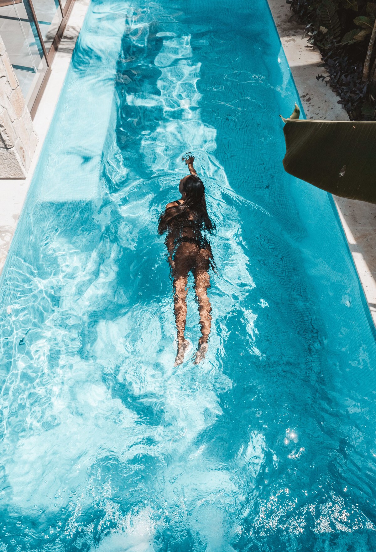A swimmer crossing the private pool at Villa Vargas Sayulita, seen from above