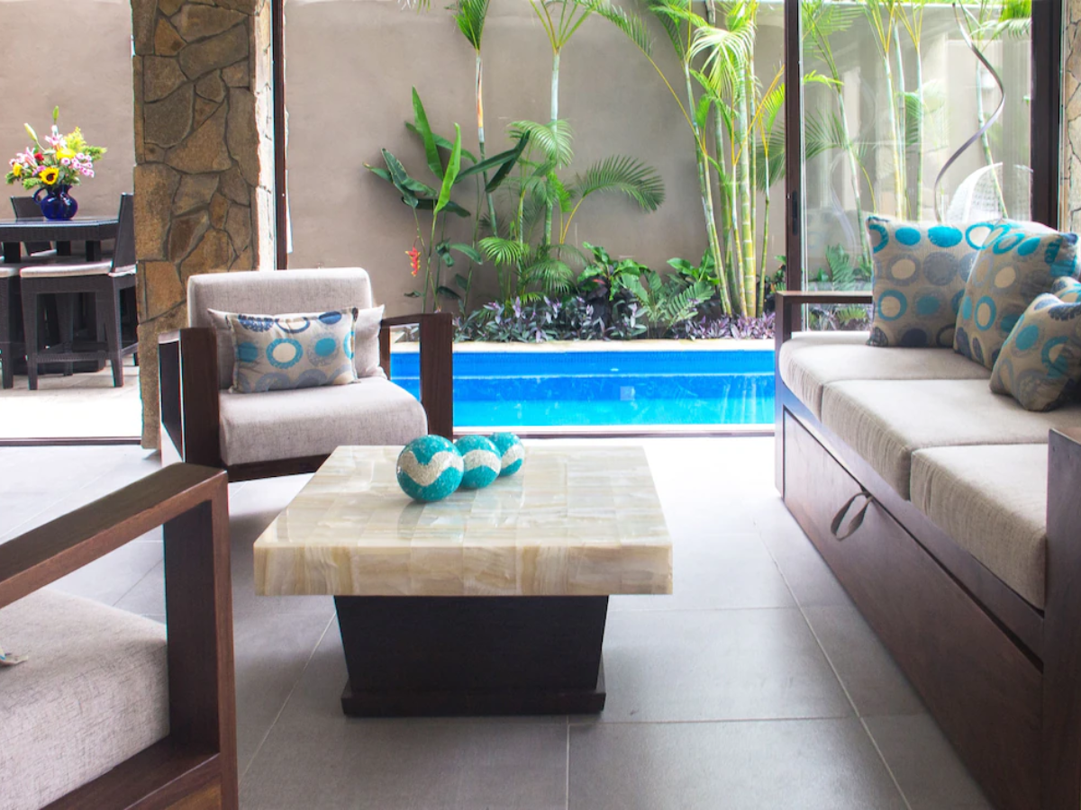 Outdoor lounge and dining area beside the pool at Villa Vargas Sayulita