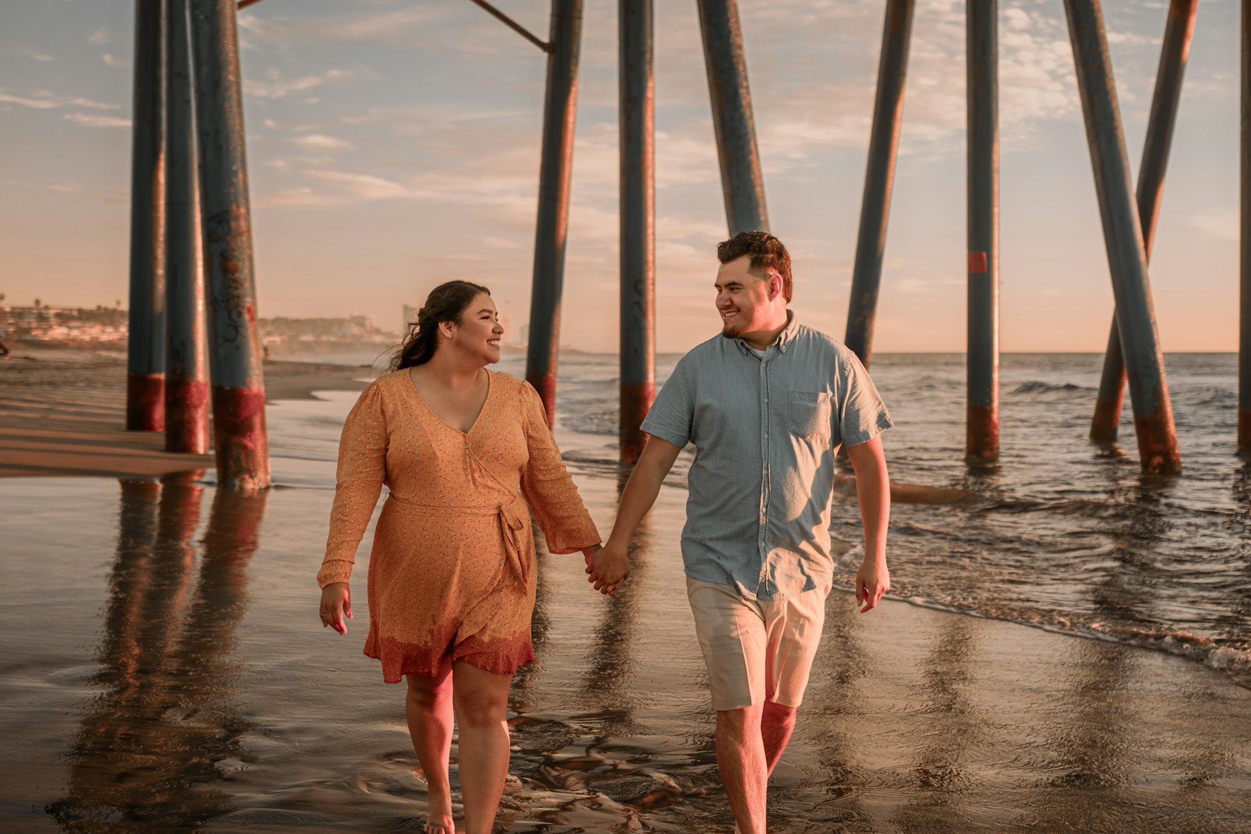 A couple walking hand in hand along the beach in Sayulita