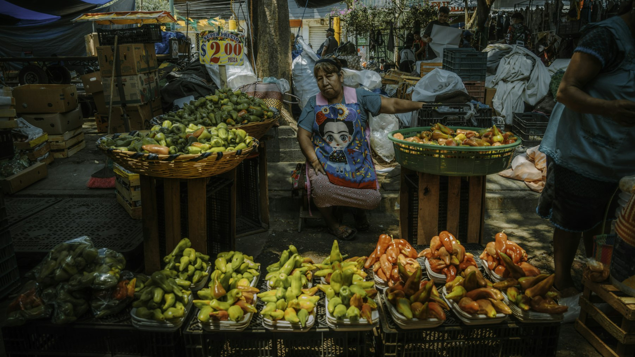 Vendor displaying fresh produce at a market, like the Sayulita farmers market