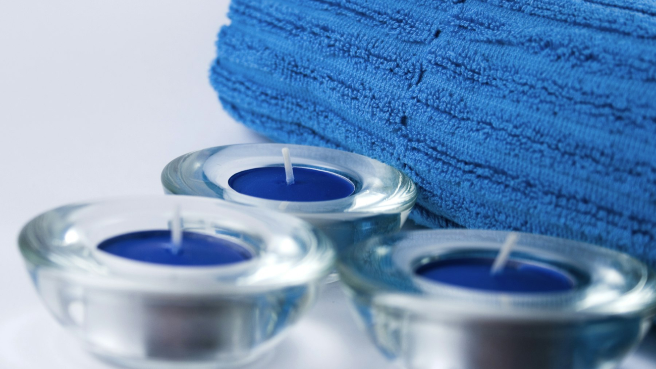 A folded towel with candles, spa day — best spas in Sayulita