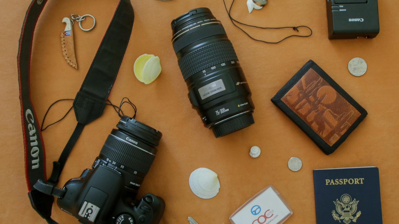 A camera, passport, wallet and keys laid out as travel essentials for a Sayulita trip