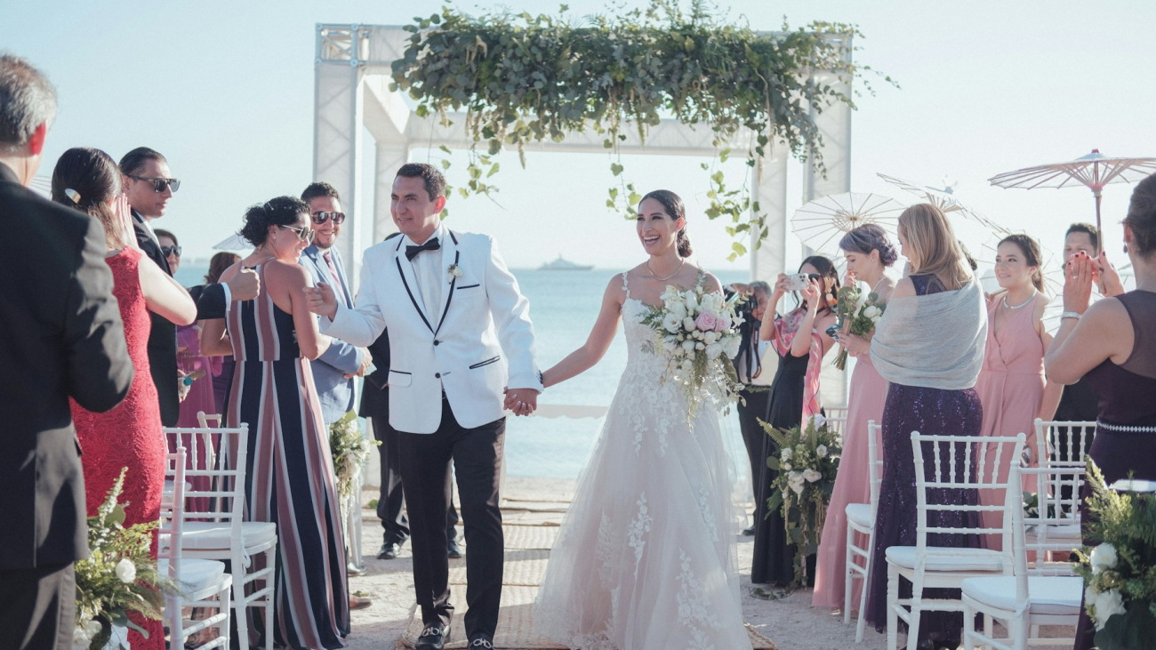 A bride and groom walking down the aisle at a beach wedding, Sayulita wedding guide